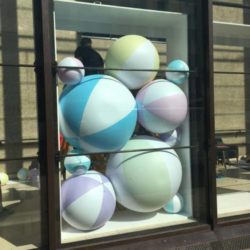 Multiple Inflatable Beach Balls Behind Glass