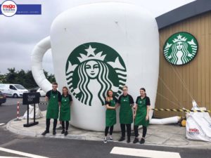 Giant inflatable Starbucks cup with Starbucks workers