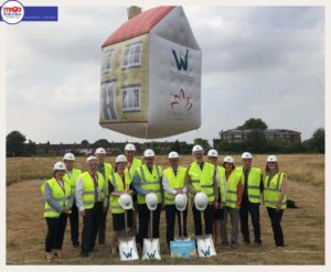 Workers under inflatable house