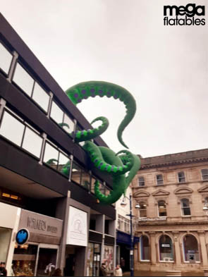 Giant inflatable squid on top of a building
