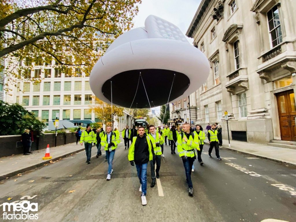 People walking with inflatables at lord mayor show 
